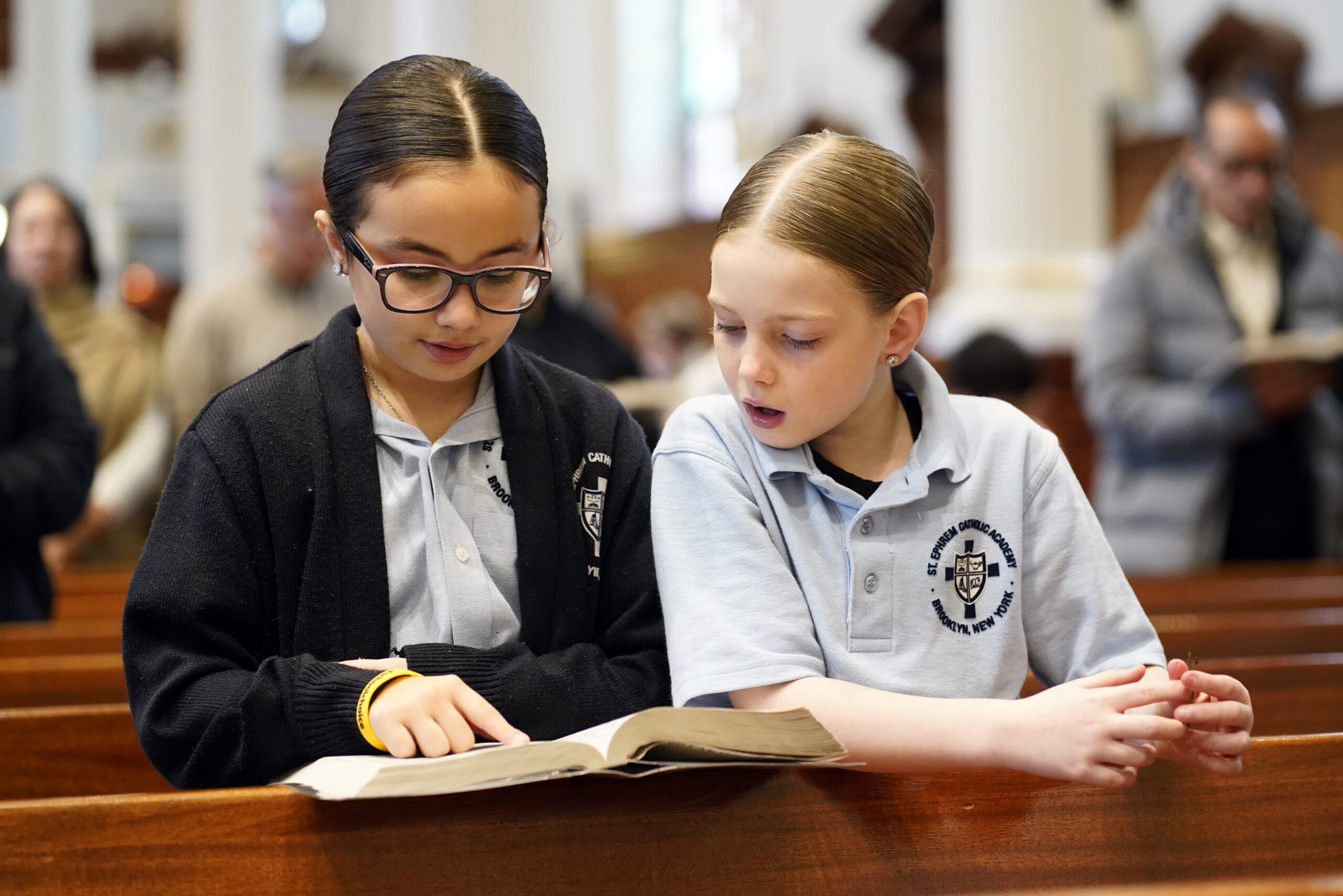 Aria Valvano, left, and Milania Phillips, third graders at St. Ephrem Catholic Academy in the Dyker Heights section of Brooklyn, N.Y., sing during a Mass marking the opening of national Catholic Schools Week at St. Ephrem Church Jan. 26, 2025. (OSV News photo/Gregory A. Shemitz)