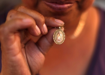 A Guatemalan woman shows her Our Lady of Guadalupe medal in Los Angeles, June 16, 2025, that she has been keeping since the immigration sweeps began. Bishop Alberto Rojas of San Bernardino, Calif., announced July 9 that he has dispensed his diocese from the obligation to attend Sunday Mass due to ongoing ICE raids. (OSV News photo/Pilar Olivares, Reuters)