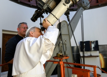 Pope Leo XIV looks through the main telescope of the Vatican Observatory in Castel Gandolfo, Italy, alongside U.S. Jesuit Father David A. Brown, an astronomer, July 20, 2025. The pope visited the observatory to mark the anniversary of the first crewed mission to land on the moon in 1969, following the recitation of the Angelus in the city’s main square. (CNS photo/Vatican Media)