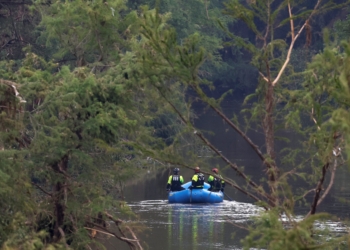 Rescuers paddle an inflatable boat as they search along a waterway in the aftermath of deadly flooding in Kerrville, Texas, July 6, 2025. At least 82 people are dead and at least 41 more are missing after devastating flash floods slammed the Texas Hill Country, with water rescues taking place along the Guadalupe River, which rose rapidly early July 4 to the height of a two-story building. Among the missing were almost a dozen from Camp Mystic in Kerr County, a children's summer camp, officials said July 6. (OSV News photo/Marco Bello, Reuters)