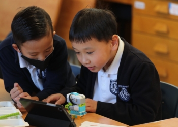 First-graders Connor Nguyen and Jasper Zhao work in a science, technology, engineering, and math program, or STEM, at Assumption of the Virgin Mary School in Pasadena, Calif. Jan. 15, 2025, in the aftermath of the Eaton Fire, which began Jan. 7. (OSV News photo/Bob Roller)