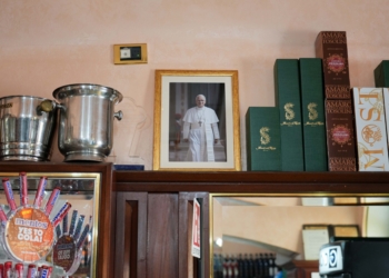 A framed photo of Pope Leo XIV is displayed inside a local café on the main square of Castel Gandolfo, Italy, July 1, 2025, as the town prepares for the pope’s first official visit for his customary July retreat. (CNS photo/Lola Gomez)