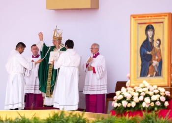 Pope Leo XIV gives his blessing after the recitation of the Angelus at the end of Mass closing the Jubilee of Youth in Rome’s Tor Vergata neighborhood Aug. 3, 2025. The icon of “Salus Populi Romani” is displayed near the altar. (CNS photo/Lola Gomez)