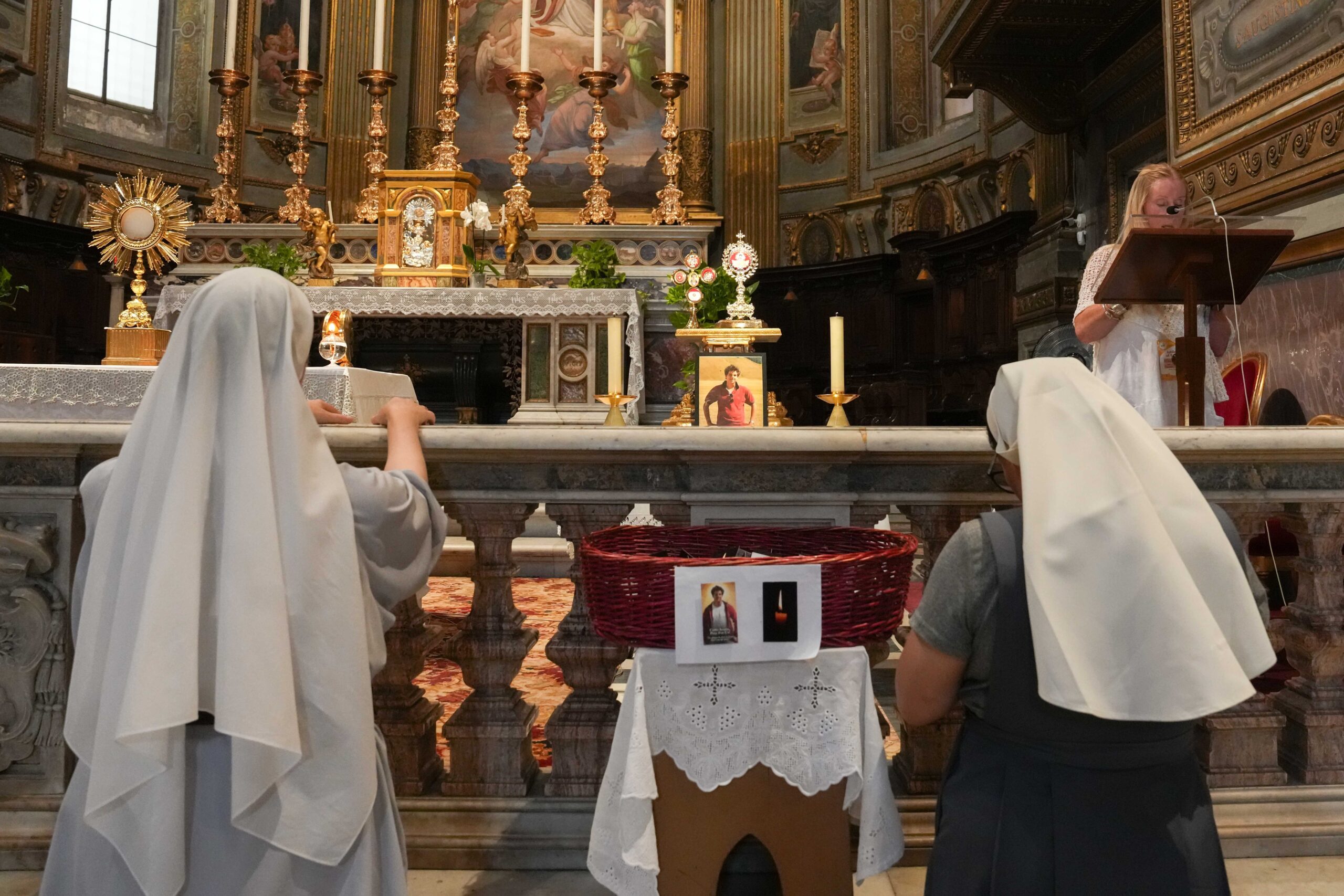 Religious sisters pray before the relics of Blessed Carlo Acutis at the Church of San Marcello al Corso in Rome July 31, 2025. (CNS photo/Lola Gomez)