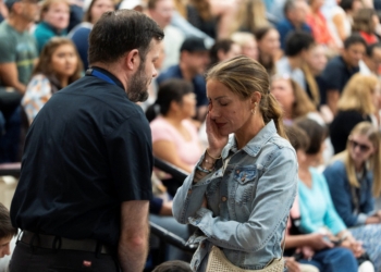 A priest comforts a woman during a prayer vigil at Academy of Holy Angels following a shooting earlier in the day at Annunciation Church in Minneapolis Aug. 27, 2025. A shooter opened fire with a rifle through the windows of a the school's church and struck children celebrating Mass during the first week of school, killing two and wounding 17 people in an act of violence the police chief called “absolutely incomprehensible.” (OSV News photo/Tim Evans, Reuters)