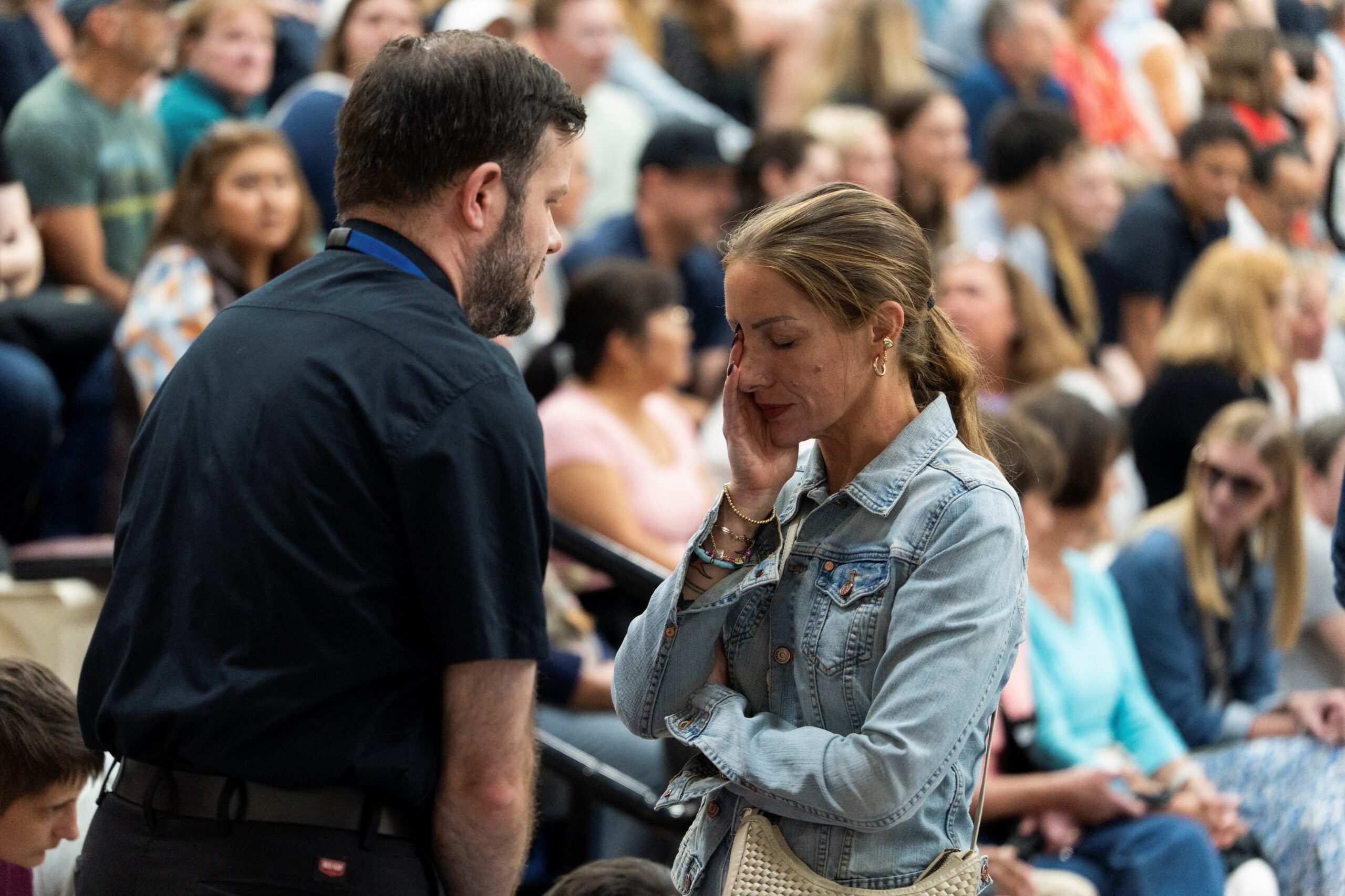 A priest comforts a woman during a prayer vigil at Academy of Holy Angels following a shooting earlier in the day at Annunciation Church in Minneapolis Aug. 27, 2025. A shooter opened fire with a rifle through the windows of a the school's church and struck children celebrating Mass during the first week of school, killing two and wounding 17 people in an act of violence the police chief called “absolutely incomprehensible.” (OSV News photo/Tim Evans, Reuters)