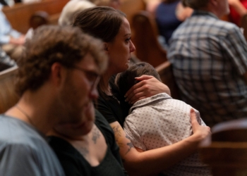 A woman holds a child during an interfaith prayer service for the Annunciation Catholic community, following a shooting at Annunciation Catholic Church on Wednesday, at the Basilica of St. Mary in Minneapolis, Minn., August 28, 2025. (OSV News photo/Tim Evans, Reuters)