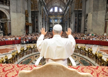 Pope Leo XIV greets pilgrims gathered inside St. Peter’s Basilica at the Vatican Aug. 13, 2025, after his weekly general audience. The pope visited them at the conclusion of the audience to offer his blessing, as the Paul VI hall had reached full capacity. (CNS photo/Vatican Media)