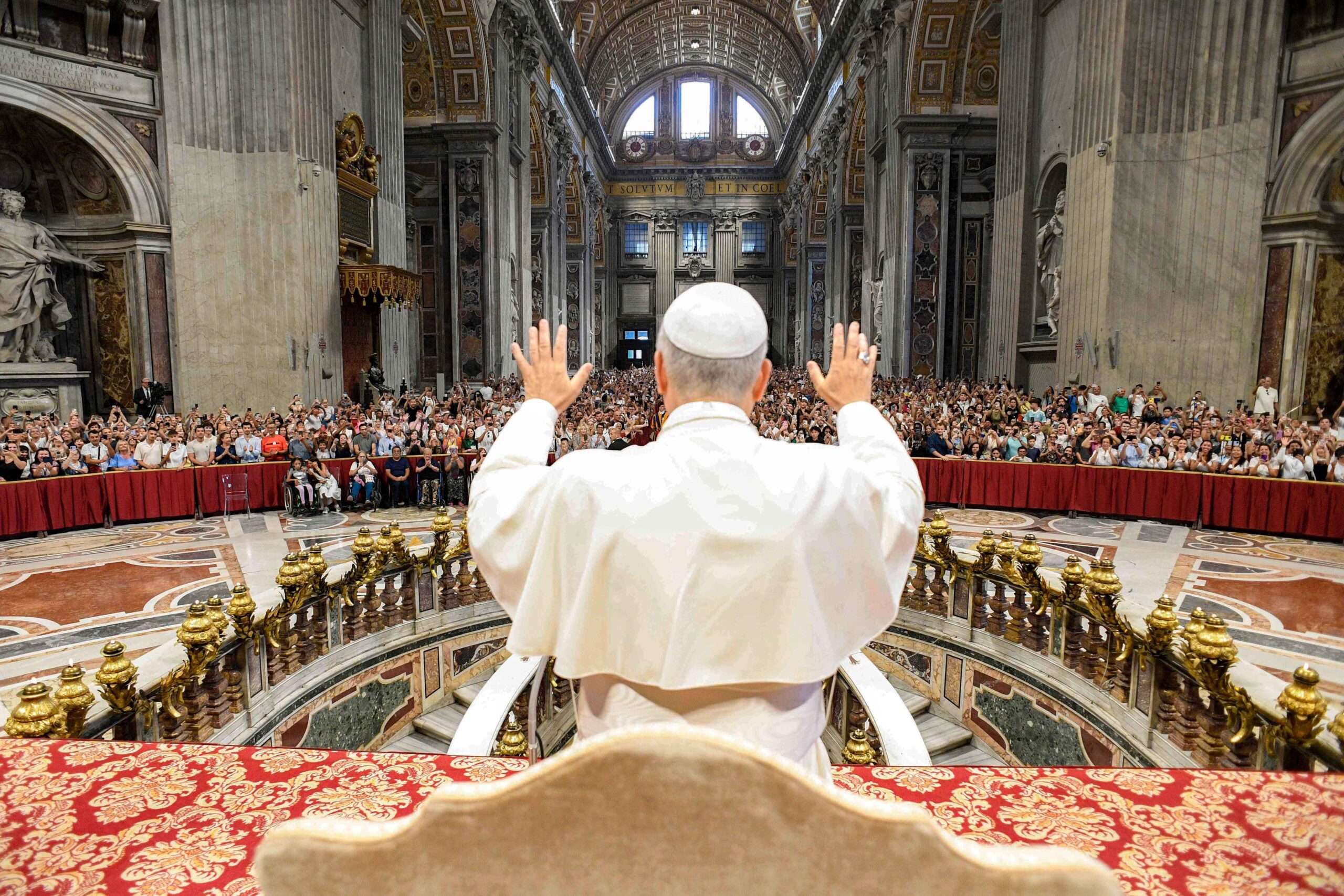 Pope Leo XIV greets pilgrims gathered inside St. Peter’s Basilica at the Vatican Aug. 13, 2025, after his weekly general audience. The pope visited them at the conclusion of the audience to offer his blessing, as the Paul VI hall had reached full capacity. (CNS photo/Vatican Media)