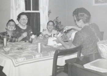 In this undated photo, Pope Leo XIV (then Robert Prevost) (left) smiles while his mother (back to the camera) cuts a birthday cake in what his brother (right) guessed was the pope's 9th birthday, at the family home in the Chicago suburb of Dolton.  (OSV News photo/Prevost family)