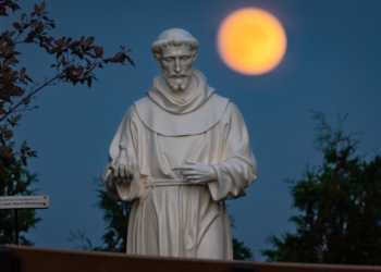 A hunter's moon rises behind a statue of St. Francis of Assisi on the grounds of the National Shrine of Our Lady of Champion in Champion, Wis., Oct 8, 2022 (OSV News photo/Sam Lucero, CNS)