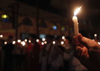 Catholics hold candles while attending a 2013 Pentecost vigil Mass at Thai Ha church in Hanoi, Vietnam. Pentecost is a time to be called to discipleship, but it's also a time for the faithful to listen and see beyond the words of Scripture and watch for the spirit of God's message. (CNS photo/Kham, Reuters) See STORIES May 18, 2015.