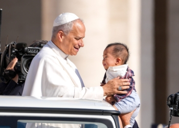 Pope Leo XIV greets a child from the popemobile as he rides around St. Peter's Square at the Vatican before his weekly general audience Sept. 17, 2025. (CNS photo/Lola Gomez)