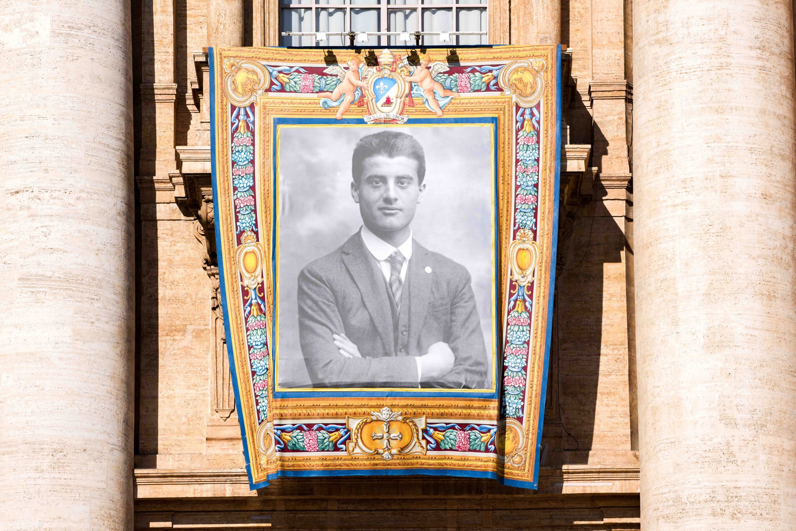 A banner with the image of St. Pier Giorgio Frassati hangs from the facade of St. Peter’s Basilica during his canonization Mass at the Vatican Sept. 7, 2025. (CNS photo/Lola Gomez)