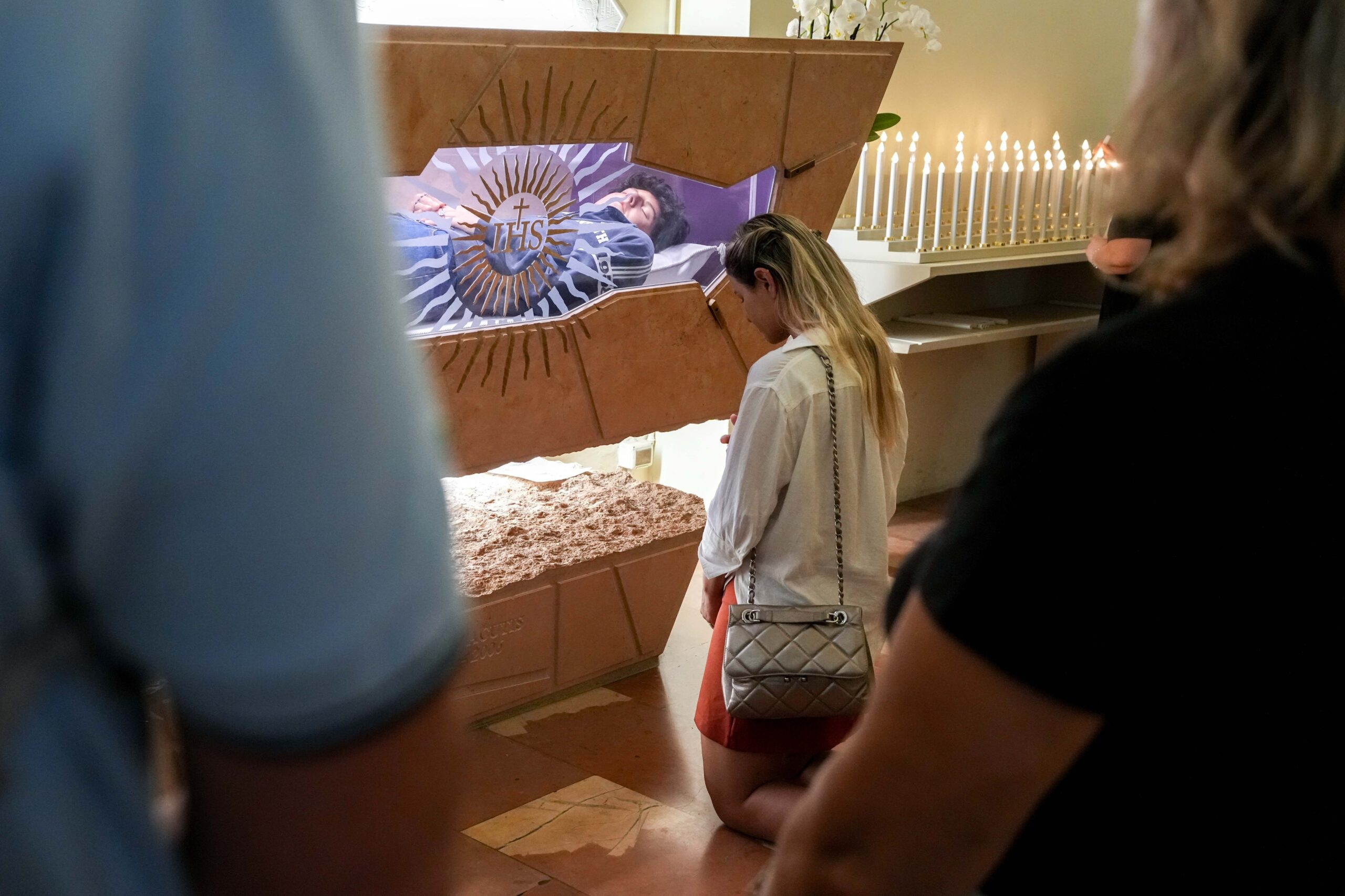 A woman kneels in prayer at the tomb of Blessed Carlo Acutis in the Sanctuary of the Renunciation in Assisi, Italy, Aug. 21, 2025. Acutis, who died in 2006 at age 15, will be canonized Sept. 7 at the Vatican by Pope Leo XIV. (CNS photo/Lola Gomez)