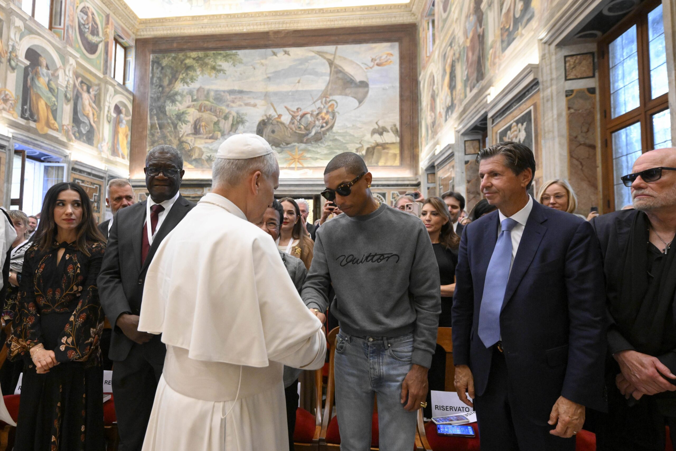 Pope Leo XIV greets American singer Pharrell Williams during a meeting on human fraternity in the Clementine Hall at the Vatican Sept. 12, 2025. (CNS photo/Vatican Media)
