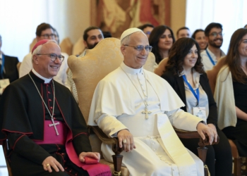 Pope Leo XIV poses for a photo with Italian Archbishop Giuseppe Baturi of Cagliari, secretary-general of the Italian bishops' conference, and members of the Youth Council of the Mediterranean at the Vatican Sept. 5, 2025. The council, coordinated by the Italian bishops, includes young adult representatives from more than a dozen Mediterranean countries. (CNS photo/Vatican Media)