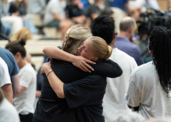 Young women embrace during a prayer vigil at the Academy of Holy Angels following a shooting earlier in the day at Annunciation Church in Minneapolis Aug. 27, 2025. A shooter opened fire with a rifle through the windows of the school's church and struck children attending Mass during the first week of school, killing two and wounding 21 people in an act of violence the police chief called "absolutely incomprehensible." (OSV News photo/Tim Evans, Reuters)