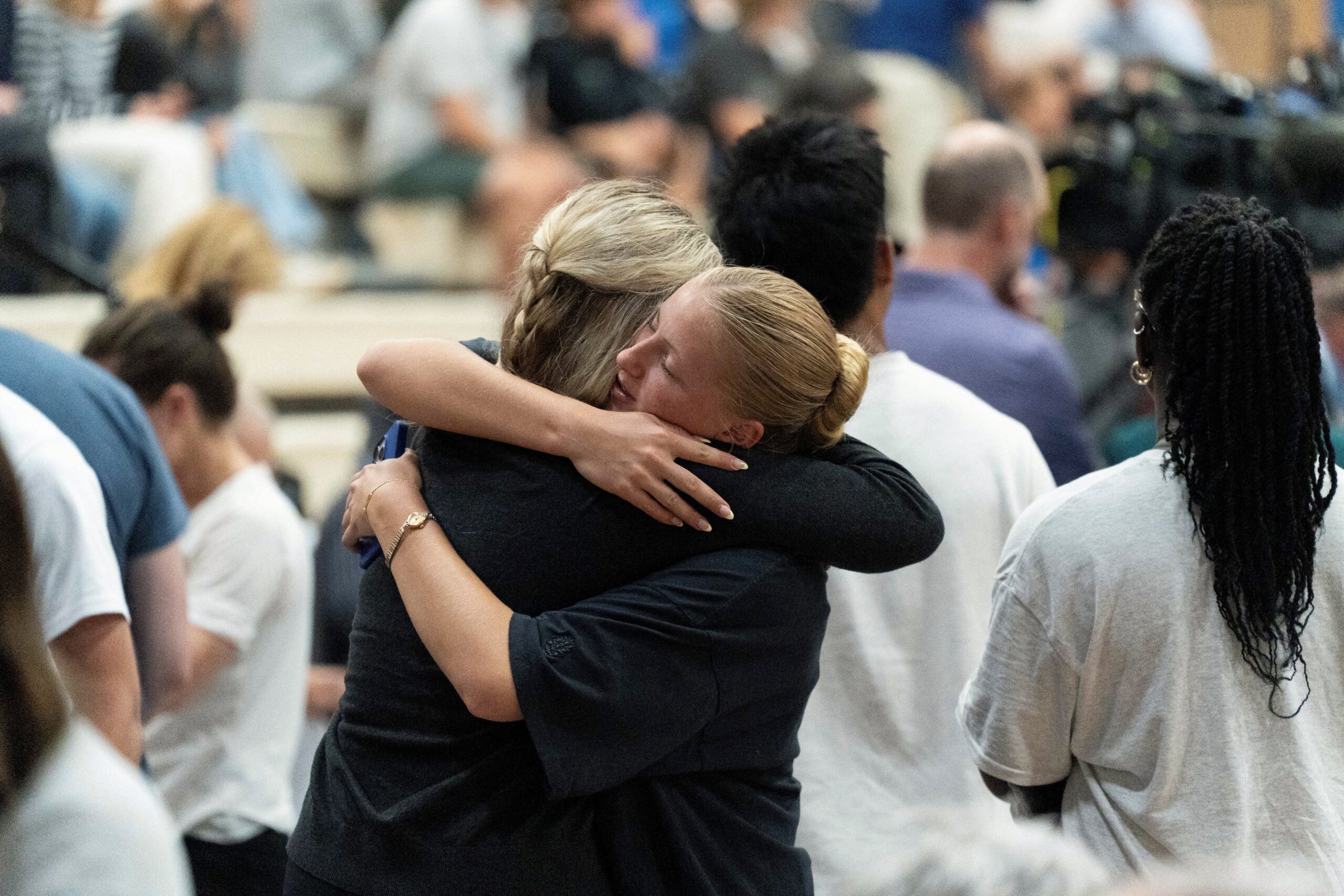 Young women embrace during a prayer vigil at the Academy of Holy Angels following a shooting earlier in the day at Annunciation Church in Minneapolis Aug. 27, 2025. A shooter opened fire with a rifle through the windows of the school's church and struck children attending Mass during the first week of school, killing two and wounding 21 people in an act of violence the police chief called "absolutely incomprehensible." (OSV News photo/Tim Evans, Reuters)