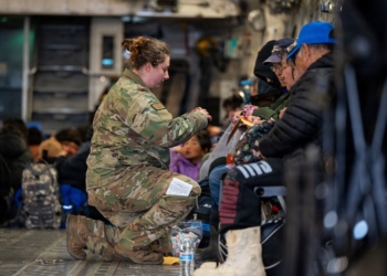 Alaska Air National Guard Tech. Sgt. Annie Kilborn secures passengers as Alaska Army National Guard evacuates people out of Bethel, following the devastating Typhoon Halong, in Alaska, Oct. 15, 2025. (OSV News photoJoseph Moon, Alaska National Guard handout via Reuters)  Editors: THIS IMAGE HAS BEEN SUPPLIED BY A THIRD PARTY. NO RESALES. NO ARCHIVES. MANDATORY CREDIT.