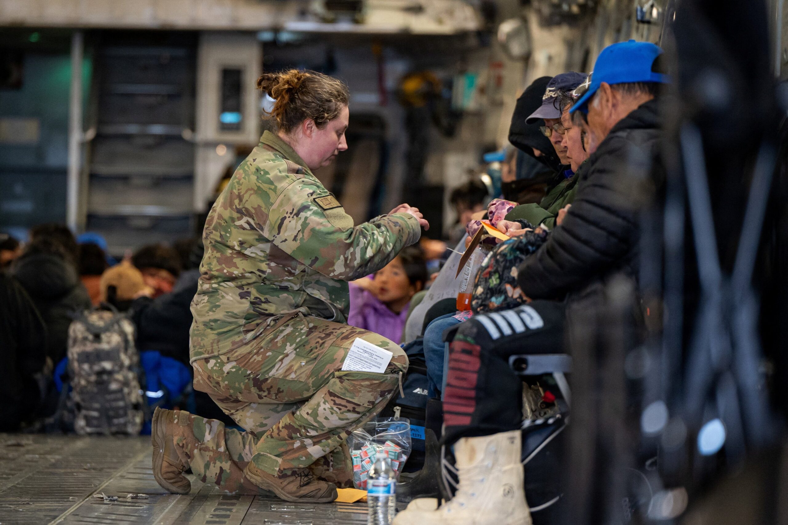 Alaska Air National Guard Tech. Sgt. Annie Kilborn secures passengers as Alaska Army National Guard evacuates people out of Bethel, following the devastating Typhoon Halong, in Alaska, Oct. 15, 2025. (OSV News photoJoseph Moon, Alaska National Guard handout via Reuters)  Editors: THIS IMAGE HAS BEEN SUPPLIED BY A THIRD PARTY. NO RESALES. NO ARCHIVES. MANDATORY CREDIT.