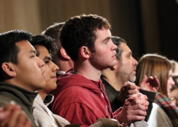 Young people are pictured in a file photo hold inghands as they pray the Lord's Prayer during the opening Mass of the National Prayer Vigil for Life at the Basilica of the National Shrine of the Immaculate Conception in Washington. (OSV News photo/Gregory A. Shemitz)