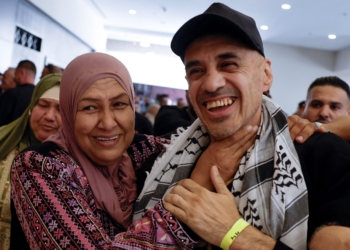 A freed Palestinian prisoner is greeted by his family member in Ramallah, in the Israeli-occupied West Bank, Oct. 13, 2025, after being released from an Israeli jail as part of a hostages-prisoners swap and a ceasefire deal in Gaza between Hamas and Israel. (OSV News photo/Mohamad Torokman, Reuters)