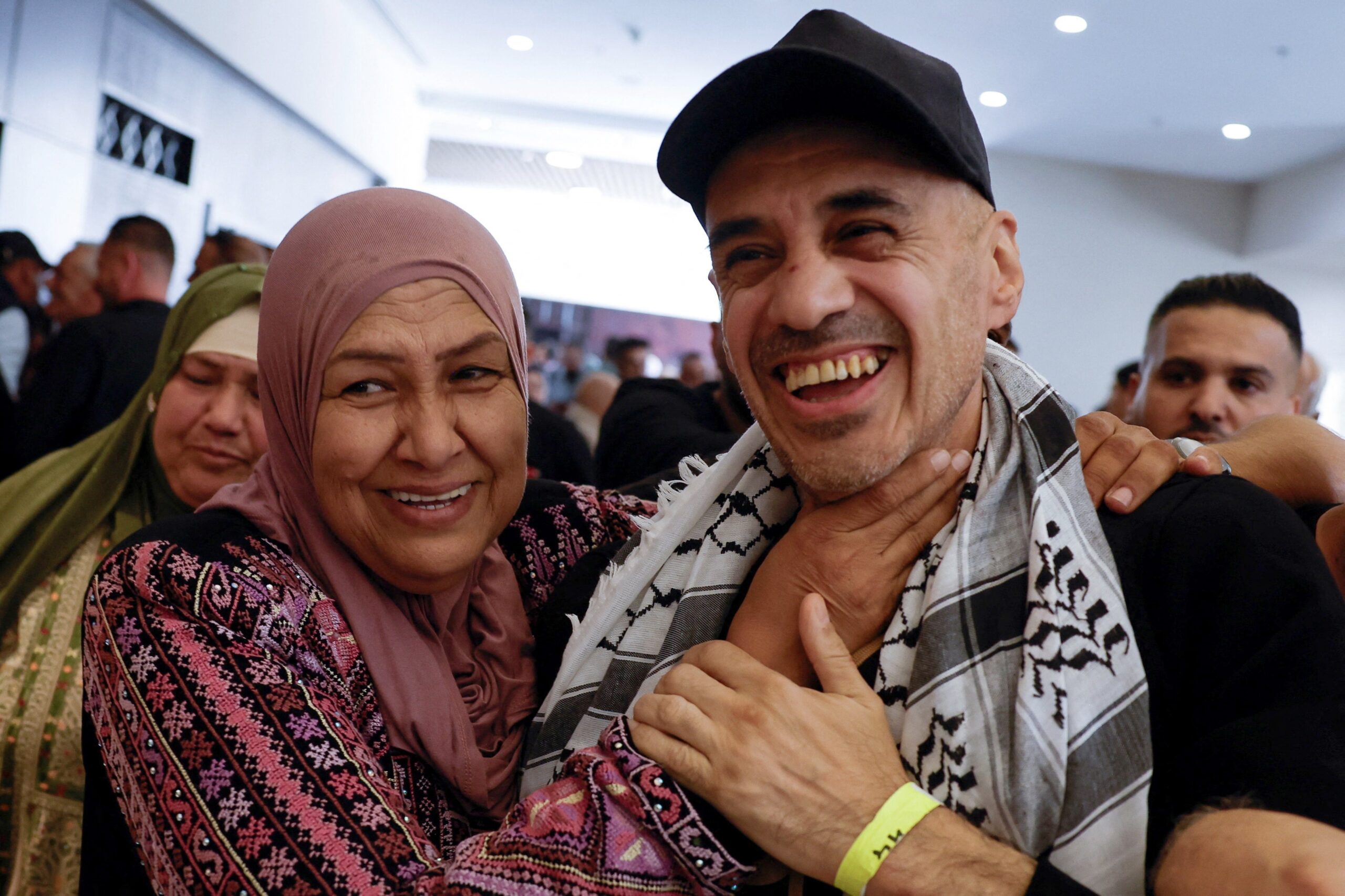 A freed Palestinian prisoner is greeted by his family member in Ramallah, in the Israeli-occupied West Bank, Oct. 13, 2025, after being released from an Israeli jail as part of a hostages-prisoners swap and a ceasefire deal in Gaza between Hamas and Israel. (OSV News photo/Mohamad Torokman, Reuters)