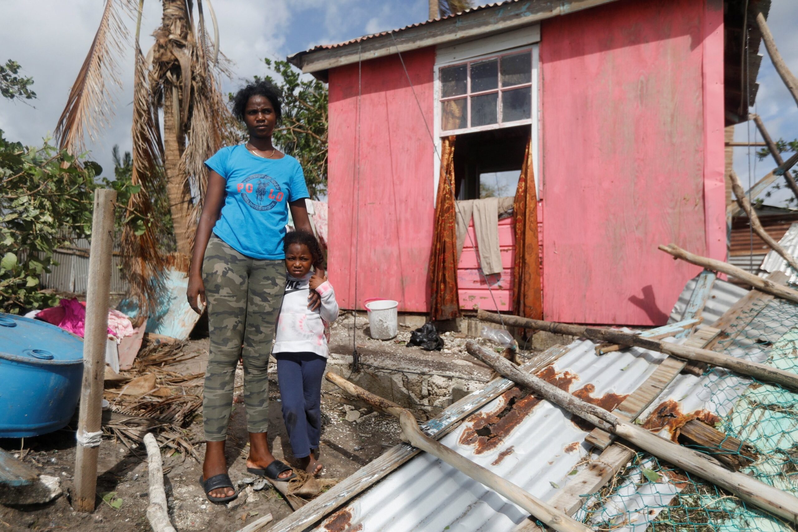 Camilla Powell 27, and daughter Destiny Ellington, 5, stand outside of their home in Alligator Pond, Jamaica, Oct. 29, 2025, after Hurricane Melissa swept through the area. Melissa made landfall Oct. 28 in Jamaica around 1 p.m. ET as a catastrophic Category 5 storm with top winds of 185 mph. One of the strongest Atlantic hurricanes on record, Melissa has left dozens dead and widespread destruction across Jamaica, Cuba and Haiti. (OSV News photo/Octavio Jones, Reuters)