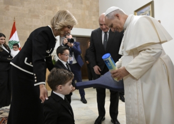 Pope Leo XIV receives a new tennis racket and balls from the grandchildren of Lebanese President Joseph Aoun and his wife, Nehmat Nehmeh, at the presidential palace in Beirut Nov. 30, 2025. (CNS photo/Vatican Media)