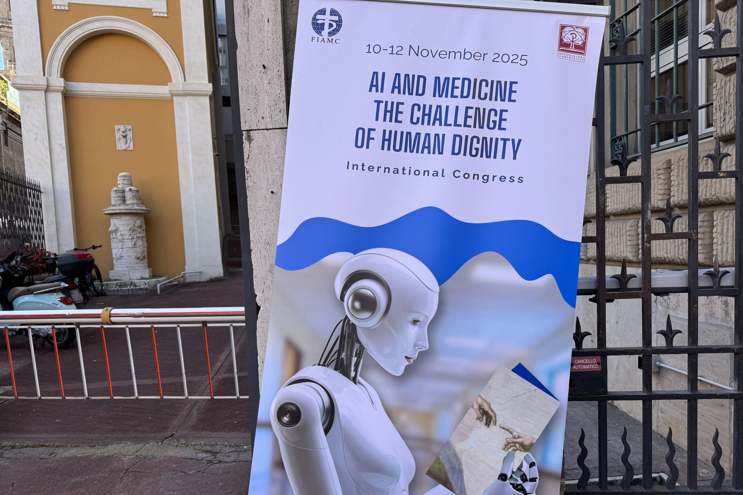 The poster for the international congress, "AI and Medicine: The Challenge of Human Dignity," sponsored by the Pontifical Academy for Life and the International Federation of Catholic Medical Associations, is seen Nov. 10, 2025, outside the Jesuit headquarters in Rome where the congress was being held. (CNS photo/Cindy Wooden)