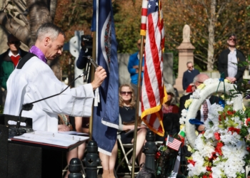 Father Anthony Marques, rector of the Cathedral of the Sacred Heart, Richmond, Va., sprinkles holy water on the grave of Eliza Monroe Hay at Hollywood Cemetery in Richmond Oct. 23, 2025.  (OSV News photo/D. Hunter Reardon, The Catholic Virginian)
