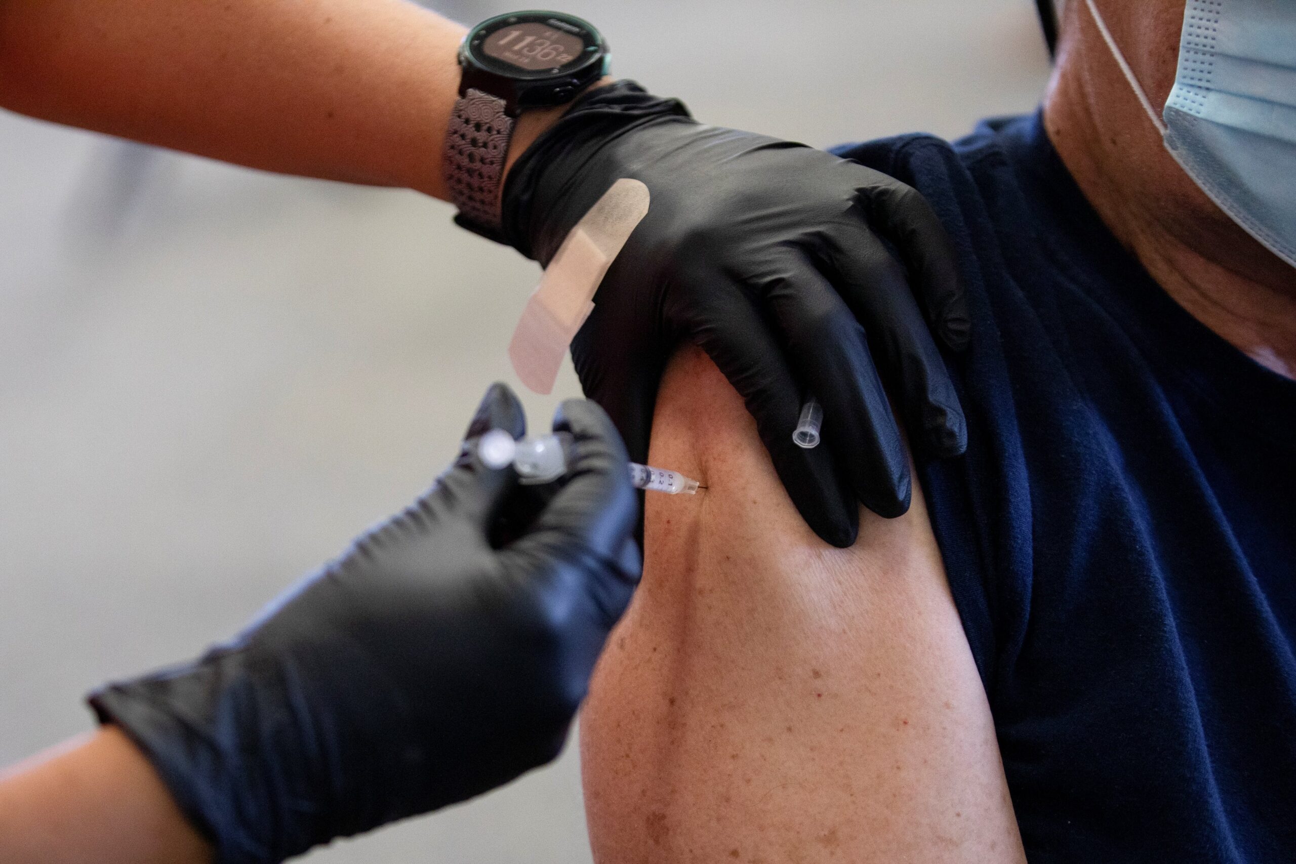 A patient receives a COVID-19 vaccine booster during a Pfizer-BioNTech vaccination clinic in Southfield, Mich., Sept. 29, 2021. The U.S. Catholic bishops have reiterated the moral permissibility of the COVID vaccines available in the United States for Catholics as booster shots become available ahead of flu and cold season. (OSV News photo/Emily Elconin, Reuters)