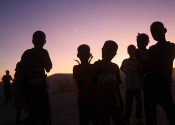 Sudanese refugee children from al-Fashir stand at sunset at the Tine transit refugee camp in eastern Chad Nov. 23, 2025, amid the ongoing conflict between the paramilitary Rapid Support Forces and the Sudanese army. Drones attacked a kindergarten and hospital in the town of Kalogi, Sudan, Dec. 4, killing more than 100 people, including children. (OSV News photo/Amr Abdallah Dalsh, Reuters)