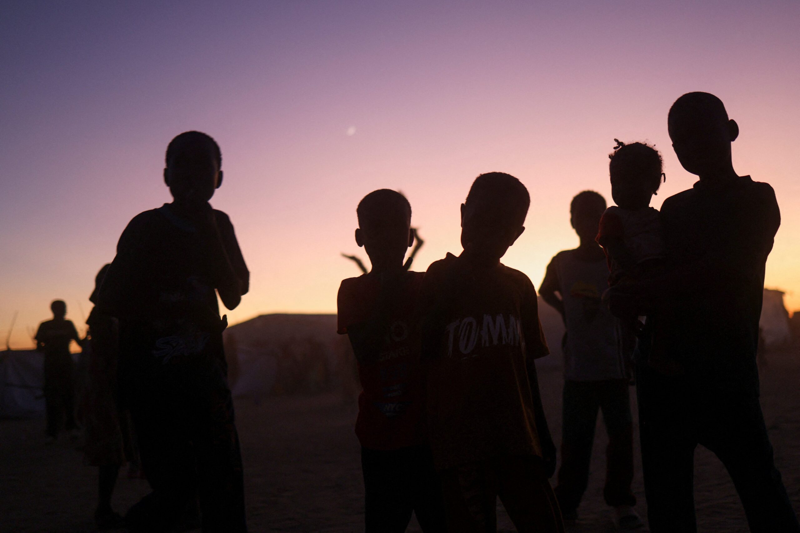 Sudanese refugee children from al-Fashir stand at sunset at the Tine transit refugee camp in eastern Chad Nov. 23, 2025, amid the ongoing conflict between the paramilitary Rapid Support Forces and the Sudanese army. Drones attacked a kindergarten and hospital in the town of Kalogi, Sudan, Dec. 4, killing more than 100 people, including children. (OSV News photo/Amr Abdallah Dalsh, Reuters)