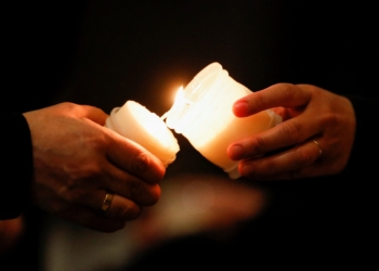 People light candles as Pope Francis celebrates Mass marking the feast of the Presentation of the Lord in St. Peter's Basilica at the Vatican Feb. 2, 2022. The Mass also marked the Vatican celebration of the World Day for Consecrated Life. (CNS photo/Remo Casilli, Reuters)