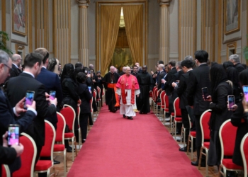 Pope Leo XIV walks down the aisle to meet with members of the diplomatic corps accredited to the Vatican at the Apostolic Palace at the Vatican Jan. 9, 2026. (CNS photo/Vatican Media)