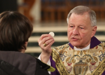 New Orleans Archbishop Gregory M. Aymond is pictured in a 2017 file photo distributing Communion during the closing Mass of the National Prayer Vigil for Life at the Basilica of the National Shrine of the Immaculate Conception in Washington. It was announced Feb. 11, 2026, that Pope Leo XIV accepted the resignation of Archbishop Aymond and appointed Coadjutor Archbishop James F. Checchio to succeed him. (CNS photo/Bob Roller)