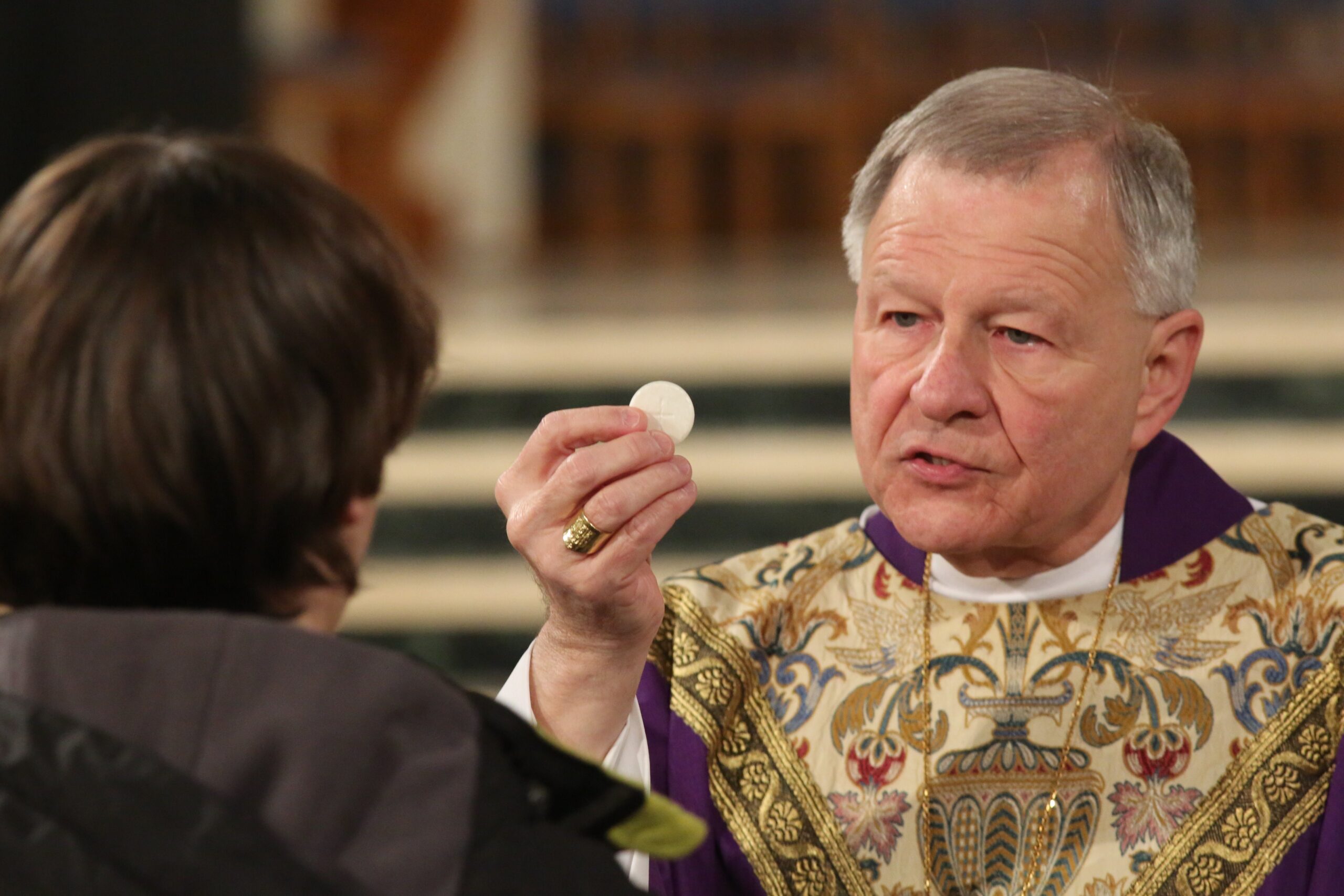 New Orleans Archbishop Gregory M. Aymond is pictured in a 2017 file photo distributing Communion during the closing Mass of the National Prayer Vigil for Life at the Basilica of the National Shrine of the Immaculate Conception in Washington. It was announced Feb. 11, 2026, that Pope Leo XIV accepted the resignation of Archbishop Aymond and appointed Coadjutor Archbishop James F. Checchio to succeed him. (CNS photo/Bob Roller)