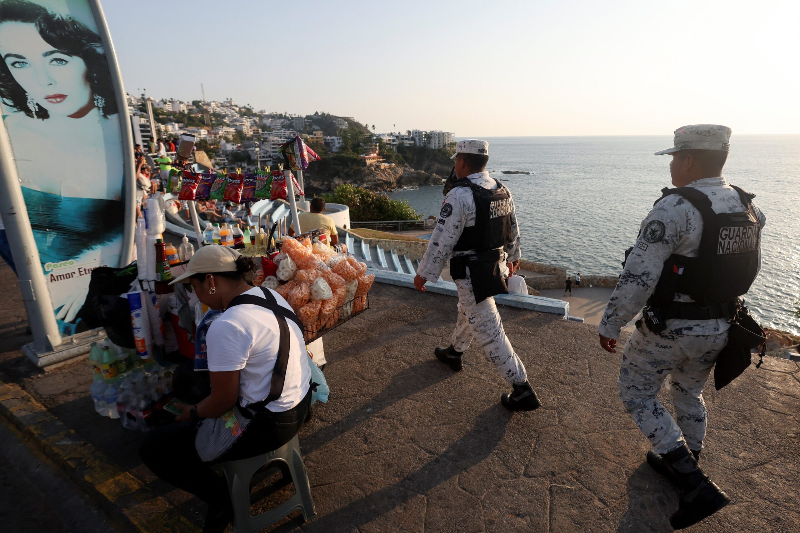 Members of the National Guard walk past people while on patrol, after authorities reinforced security following roadblocks and arson attacks carried out by organised crime in several states, in the aftermath of a military operation in which a Mexican drug lord Nemesio Oseguera, known as "El Mencho," was killed in Jalisco state, in Acapulco, Mexico, Feb. 22, 2026. (OSV News photo/Henry Romeroin, Reuters)