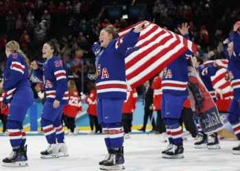 Haley Winn of the U.S. Women's Hockey Team celebrates with her medal and national flag during the victory ceremony during the ceremony after they won in overtime defeating Canada 2-1 during the Milano Cortina 2026 Olympics at Milano Santagiulia Ice Hockey Arena in Milan, Italy, Feb. 19, 2026. (OSV News photo/David W Cerny, Reuters)