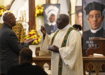 Deacon Michel Hodge distributes the Holy Eucharist during Mass at the inaugural New York Black Catholic Congress last November at Blessed Sacrament Church in New Rochelle, N.Y. In a statement commemorating this year’s Black History Month, the U.S. bishops say, “During this year’s observance of Black History Month, we encourage the faithful to consider the lessons of history, honoring our heroes of the past and learning from the mistakes of the past.” (OSV News photo/Gregory A. Shemitz)
