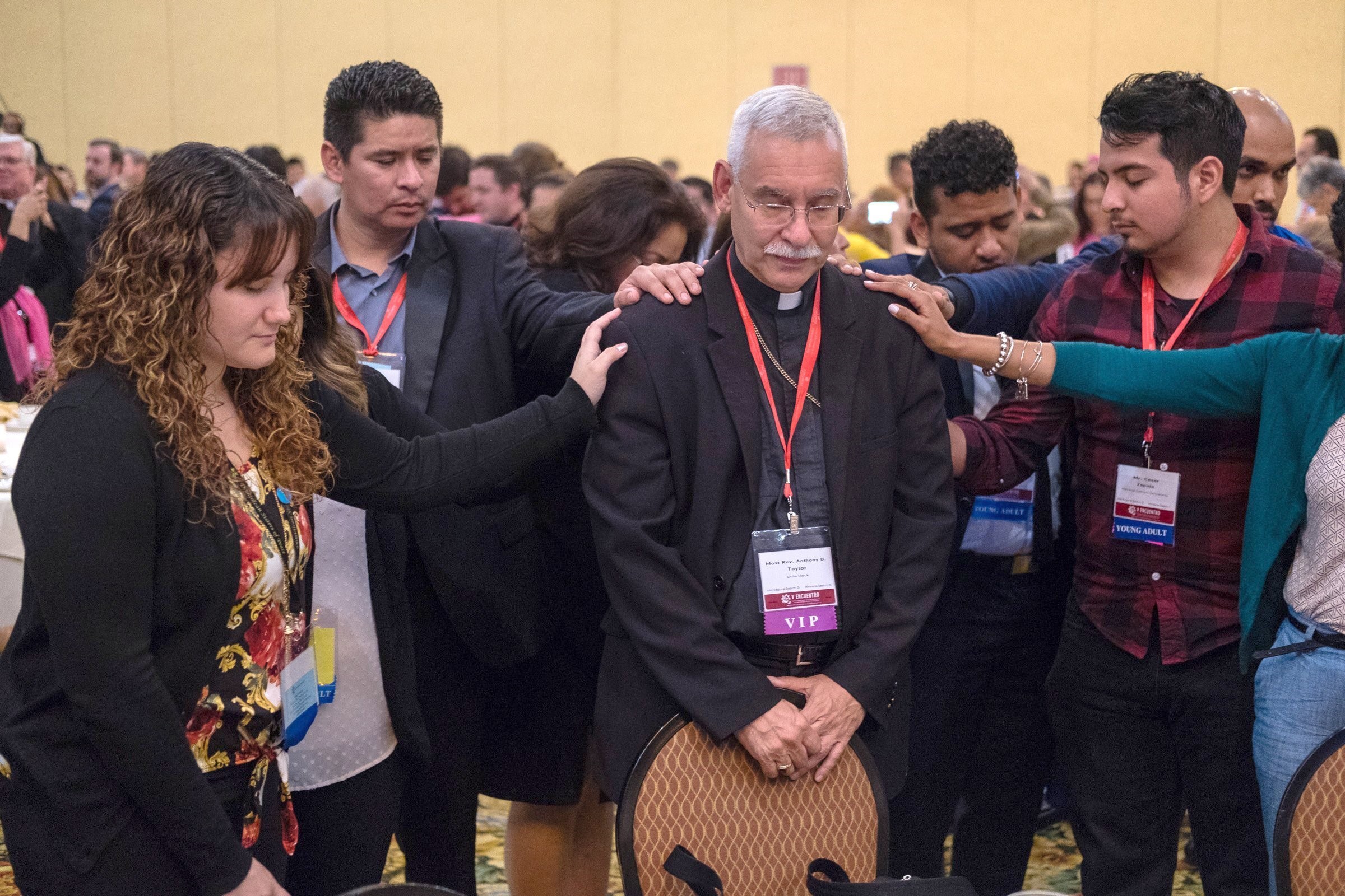 Young Catholic adults are pictured in a file photo praying over Bishop Anthony B. Taylor of Little Rock, Ark., during an evening encounter between young adults and their bishops at the Fifth National Encuentro in Grapevine, Texas. Younger Catholic adults in the U.S. are more likely to be Hispanic or Latino, while just over half of Gen-Z individuals raised Catholic are likely to retain that identity in adulthood, according to a March 23, 2026, data analysis by Mark Gray of the Center for Applied Research in the Apostolate. (OSV News photo/James Ramos, Texas Catholic Herald)