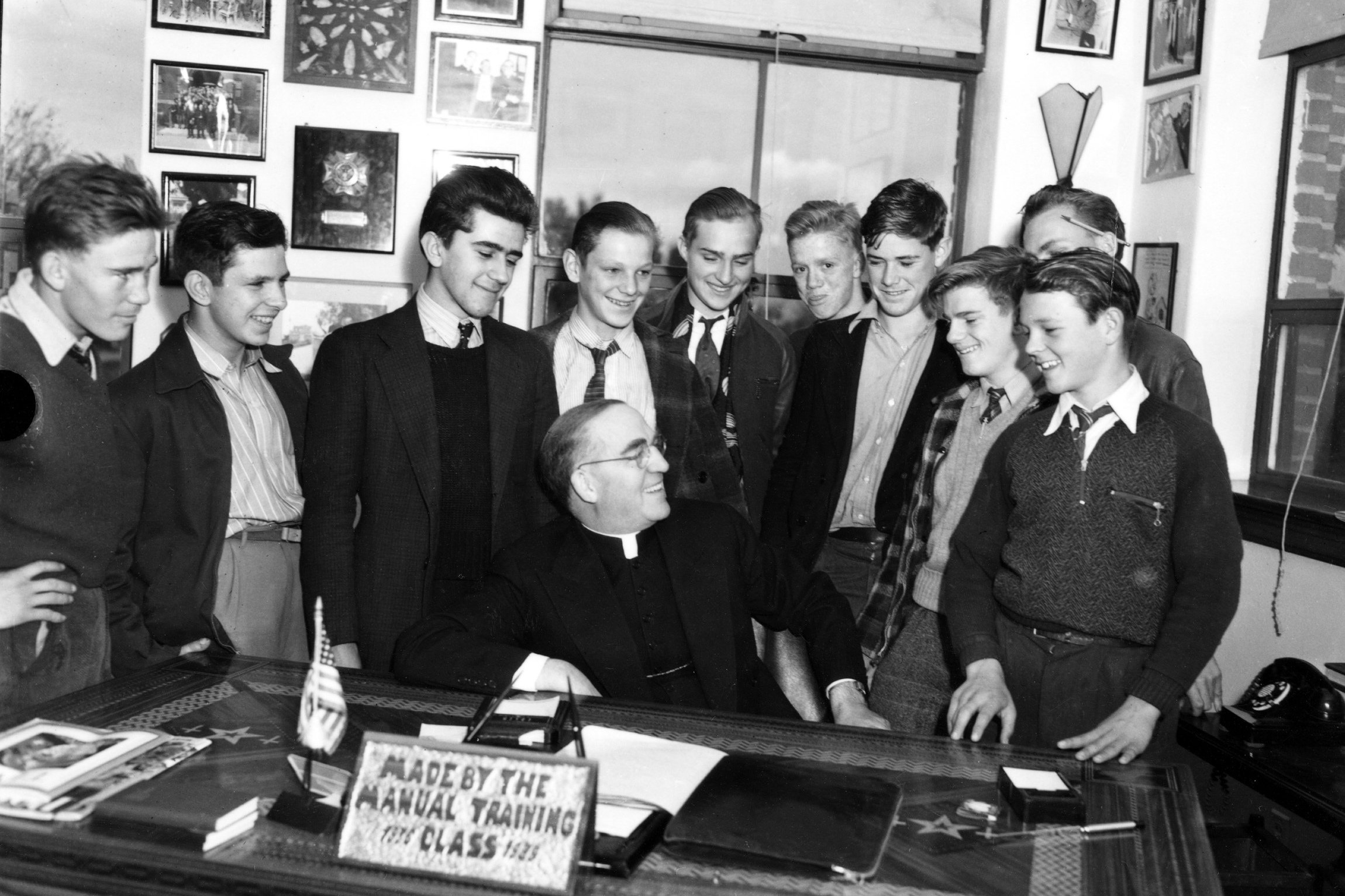 Father Edward Flanagan is surrounded by young men in his office at Boys Town in Omaha, Neb., in this 1942 photo. Pope Leo XIV declared Father Flanagan, the founder of Boys Town, venerable in recognition of his heroic virtue March 23, 2026. (OSV News photo/courtesy Boys Town)
