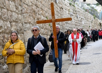 Catholic tourists from Rome carry a cross along the Via Dolorosa, the Way of the Cross, in the Old City of Jerusalem March 23, 2024, the eve of Palm Sunday and the start of Holy Week. (OSV News photo/Debbie Hill)