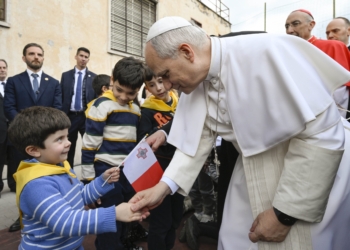 Pope Leo XIV greets a child holding the flag of Malta during a parish visit to the Church of the Sacred Heart of Jesus in Rome, Italy, March 15, 2026.  As the U.S. marks its 250th anniversary, Pope Leo XIV, the first American pontiff in history, will receive the National Constitution Center's Liberty Medal for his promotion of religious liberty, as well as freedom of conscience and expression. (CNS photo/Vatican Media)