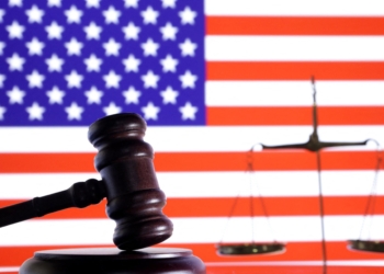 The U.S. flag, a judge gavel and a vintage scale are seen in this illustration from Aug. 6, 2024. A federal judge paused Louisiana's lawsuit challenging the FDA's approval of mifepristone pending its promised safety review. But indicated the state could continue its challenge after that review. (OSV News photo/Dado Ruvic, Reuters)