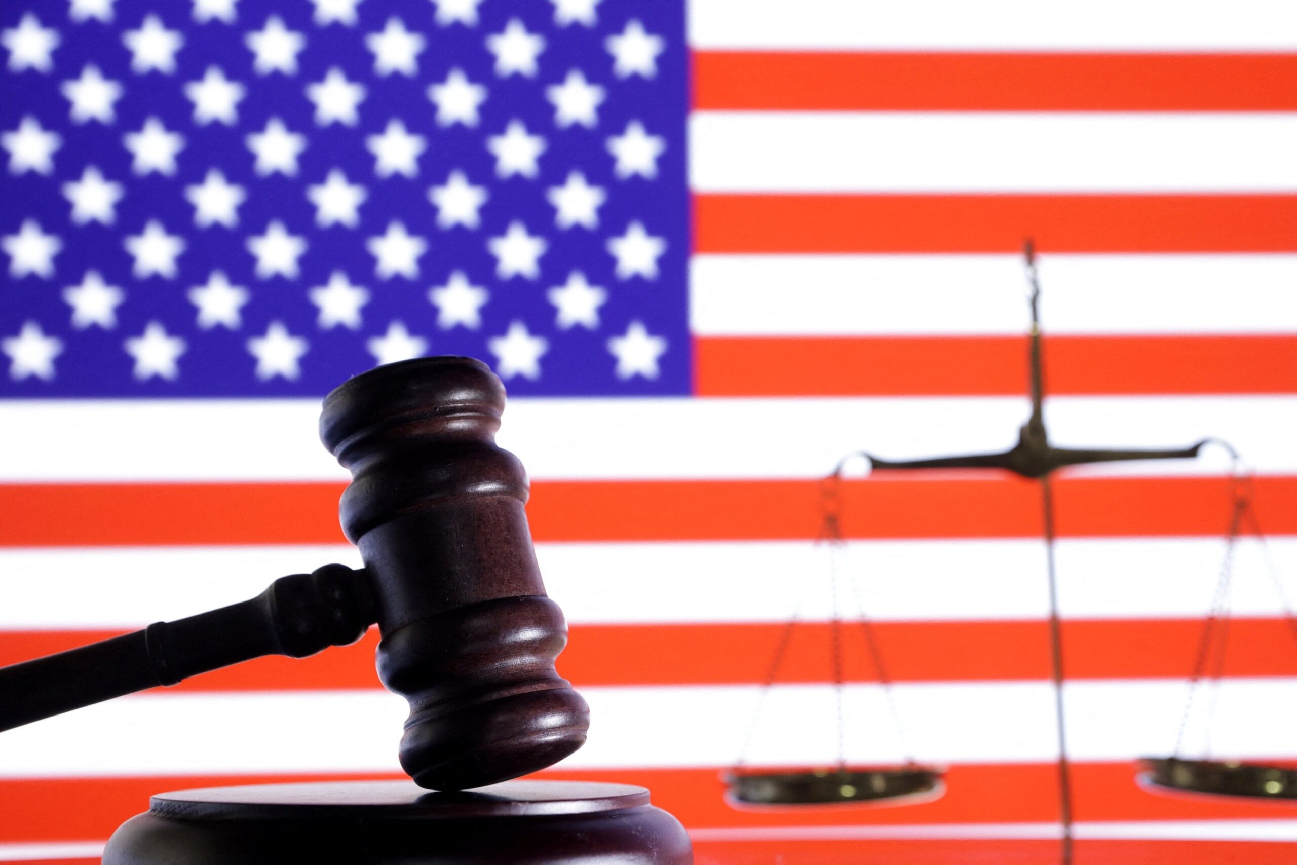 The U.S. flag, a judge gavel and a vintage scale are seen in this illustration from Aug. 6, 2024. A federal judge paused Louisiana's lawsuit challenging the FDA's approval of mifepristone pending its promised safety review. But indicated the state could continue its challenge after that review. (OSV News photo/Dado Ruvic, Reuters)