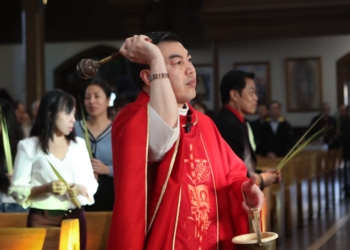Father Loi Tran, CSF, blesses palm leaves during the Palm Sunday Vietnamese Mass at the Parish of Saint Monica, Our Lady Star of Sea Church in Atlantic City, Sunday, March 29, 2026.