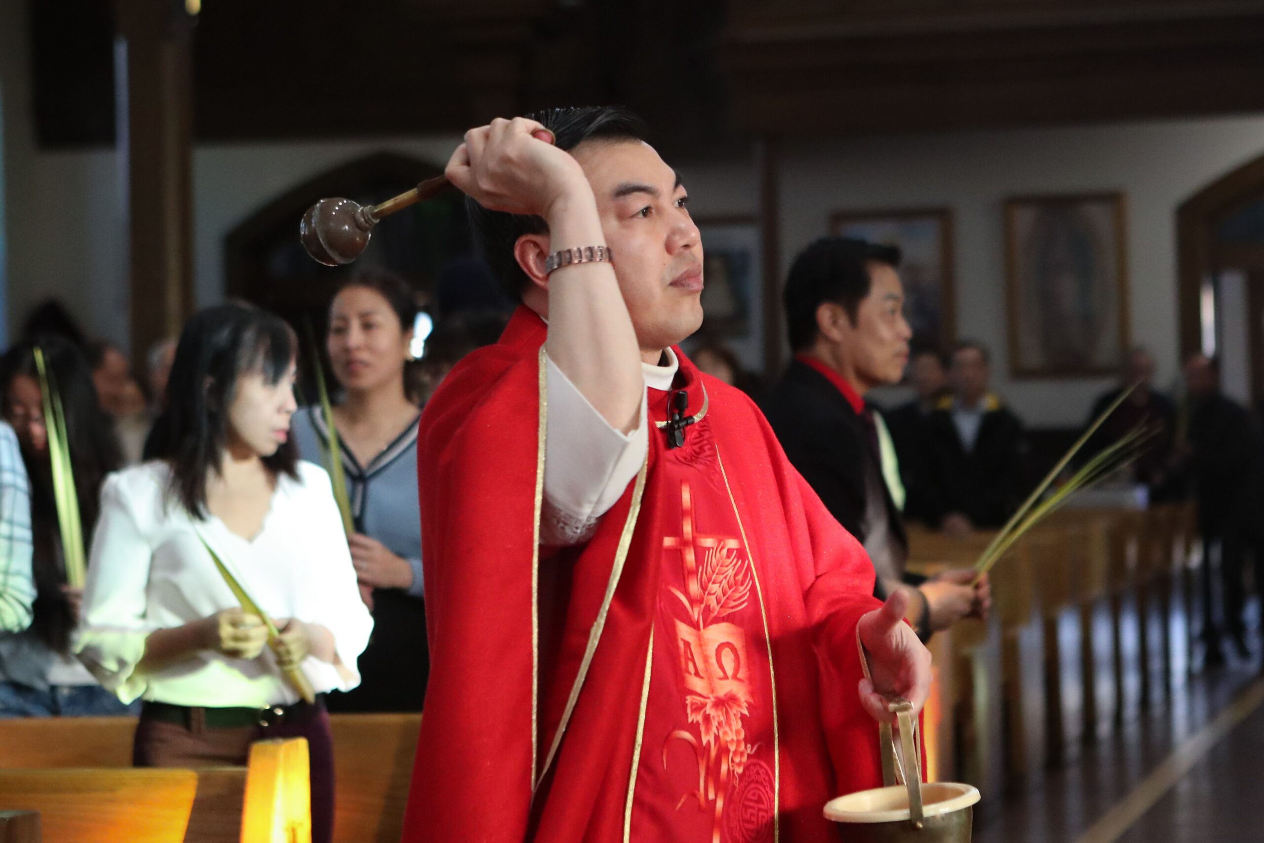 Father Loi Tran, CSF, blesses palm leaves during the Palm Sunday Vietnamese Mass at the Parish of Saint Monica, Our Lady Star of Sea Church in Atlantic City, Sunday, March 29, 2026.